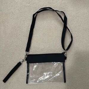 Clear adjustable cross-body purse.